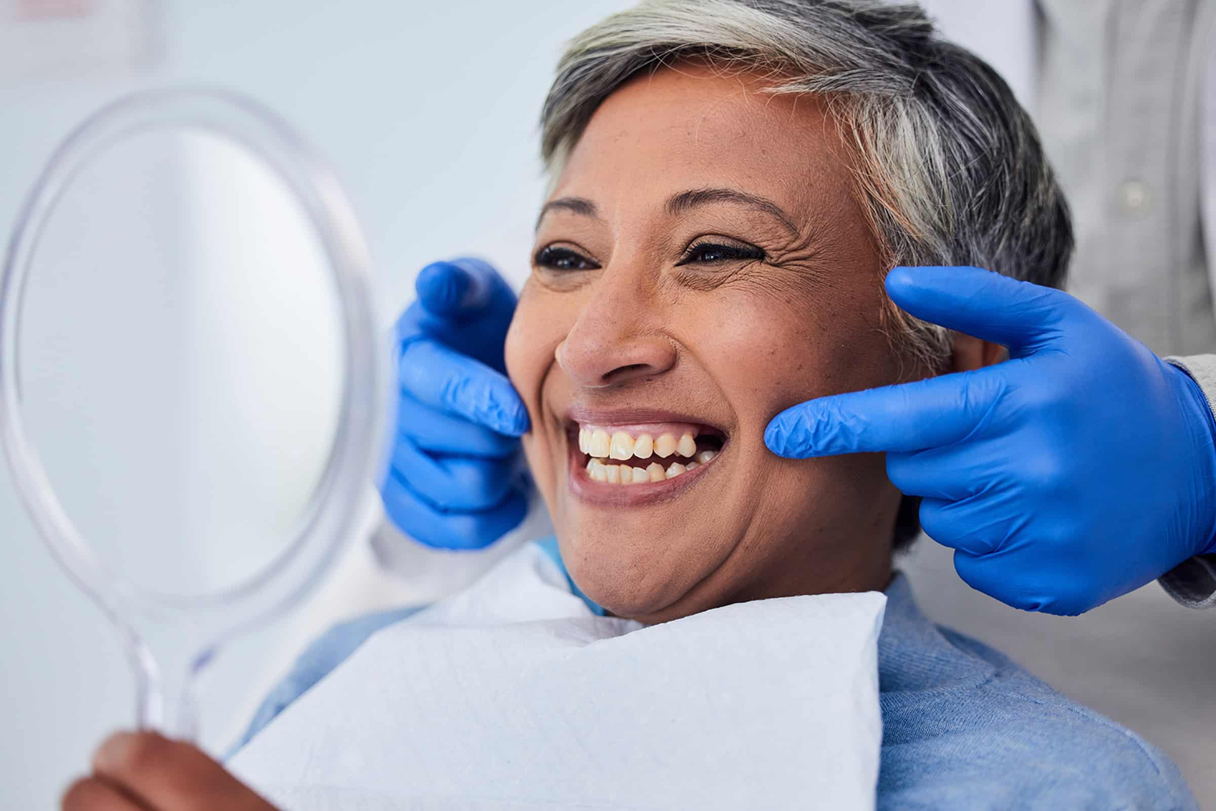 Woman smiling after getting cosmetic dental services in Lone Tree, CO