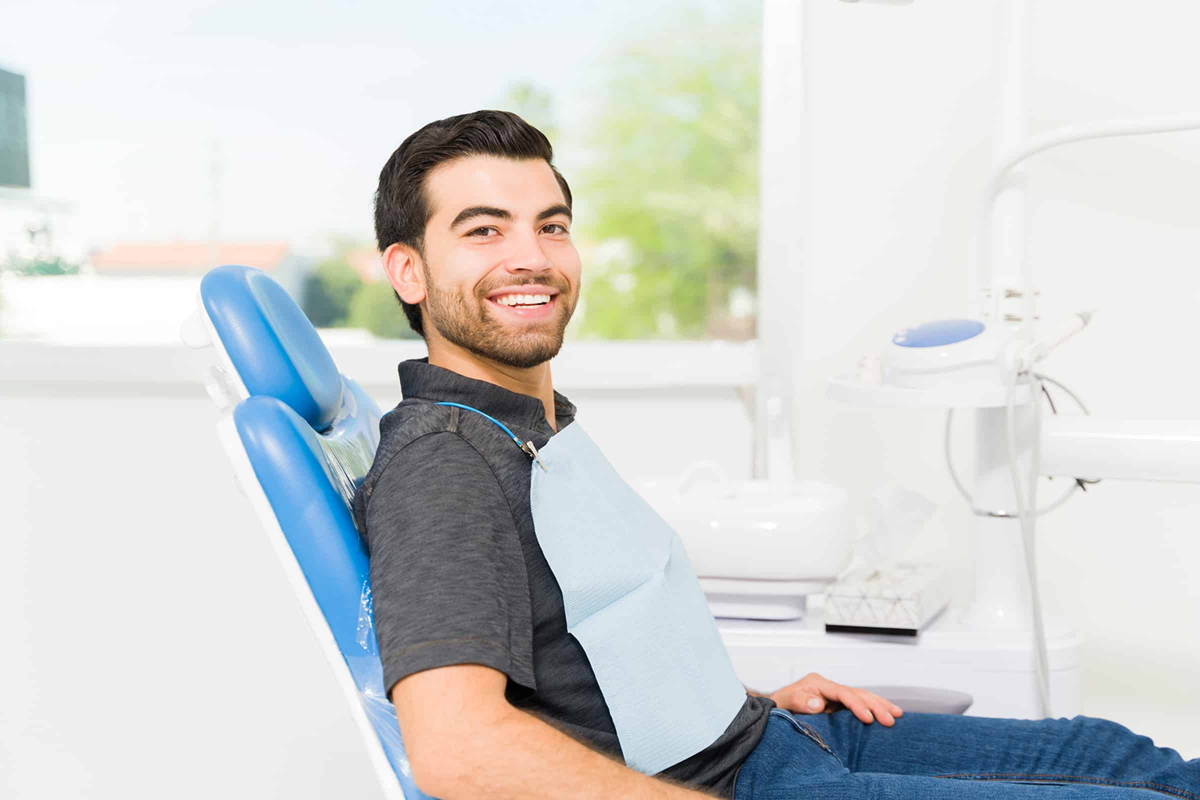 Man smiling at a routine dental check up in Highlands Ranch, CO
