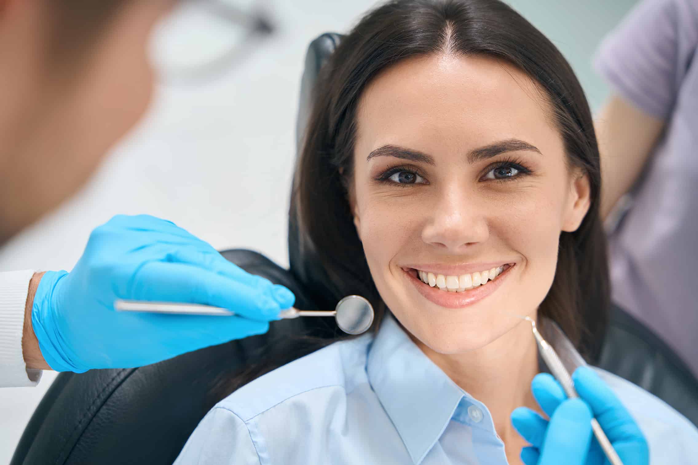 woman smiling at dental appointment - Willow Creek Dental