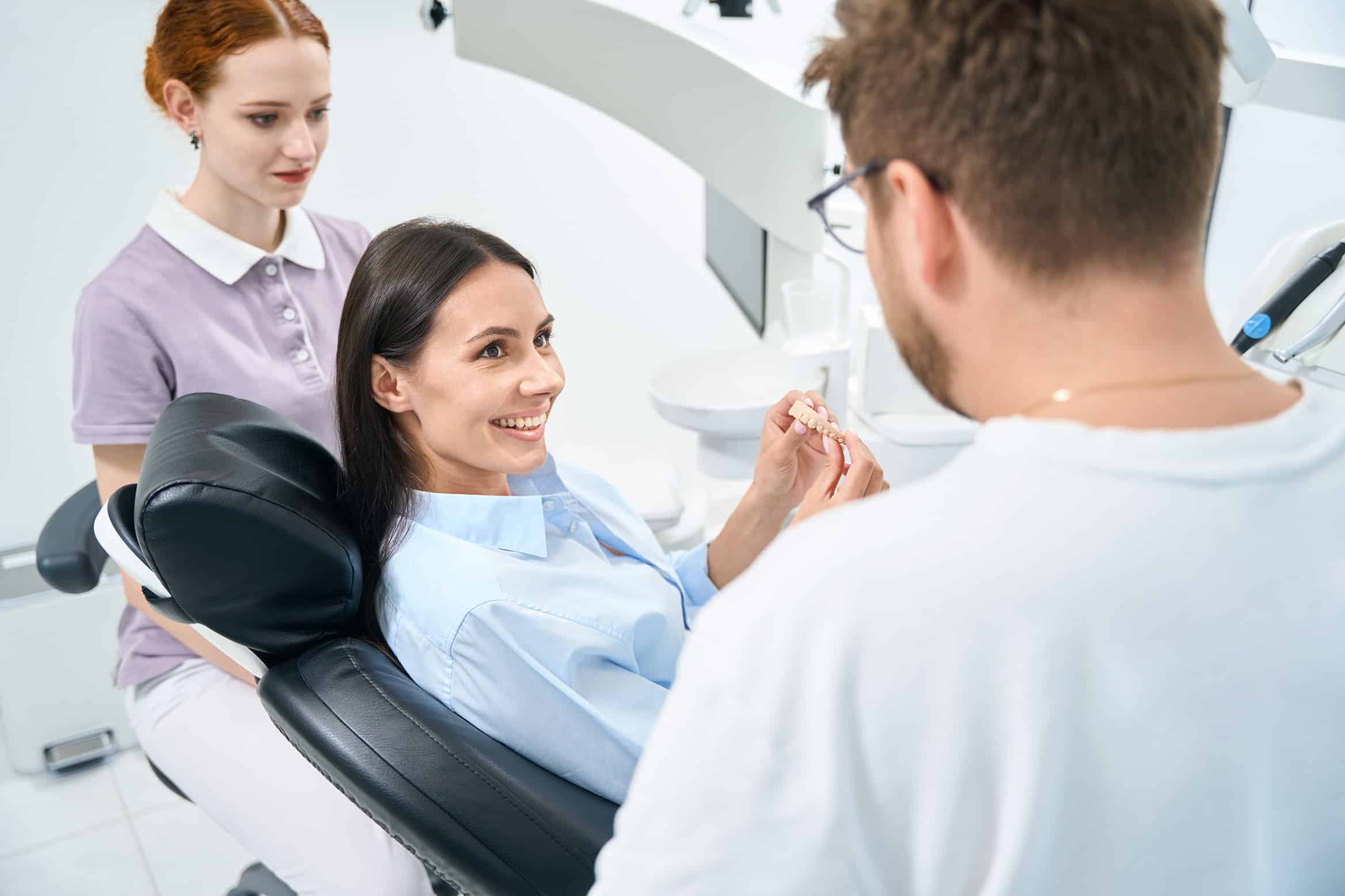 woman smiling at dental appointment in Lone Tree, CO